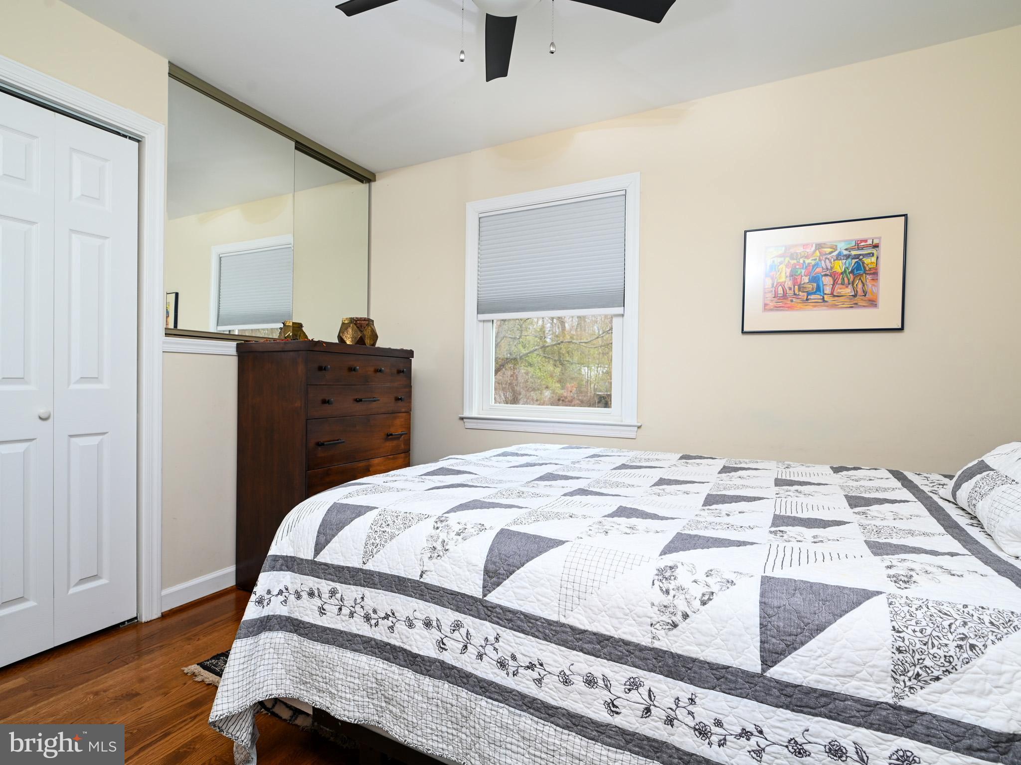 7951 Jansen Drive Springfield, VA 22152 - Photo 16 of 36 a bedroom with a bed and wooden floor