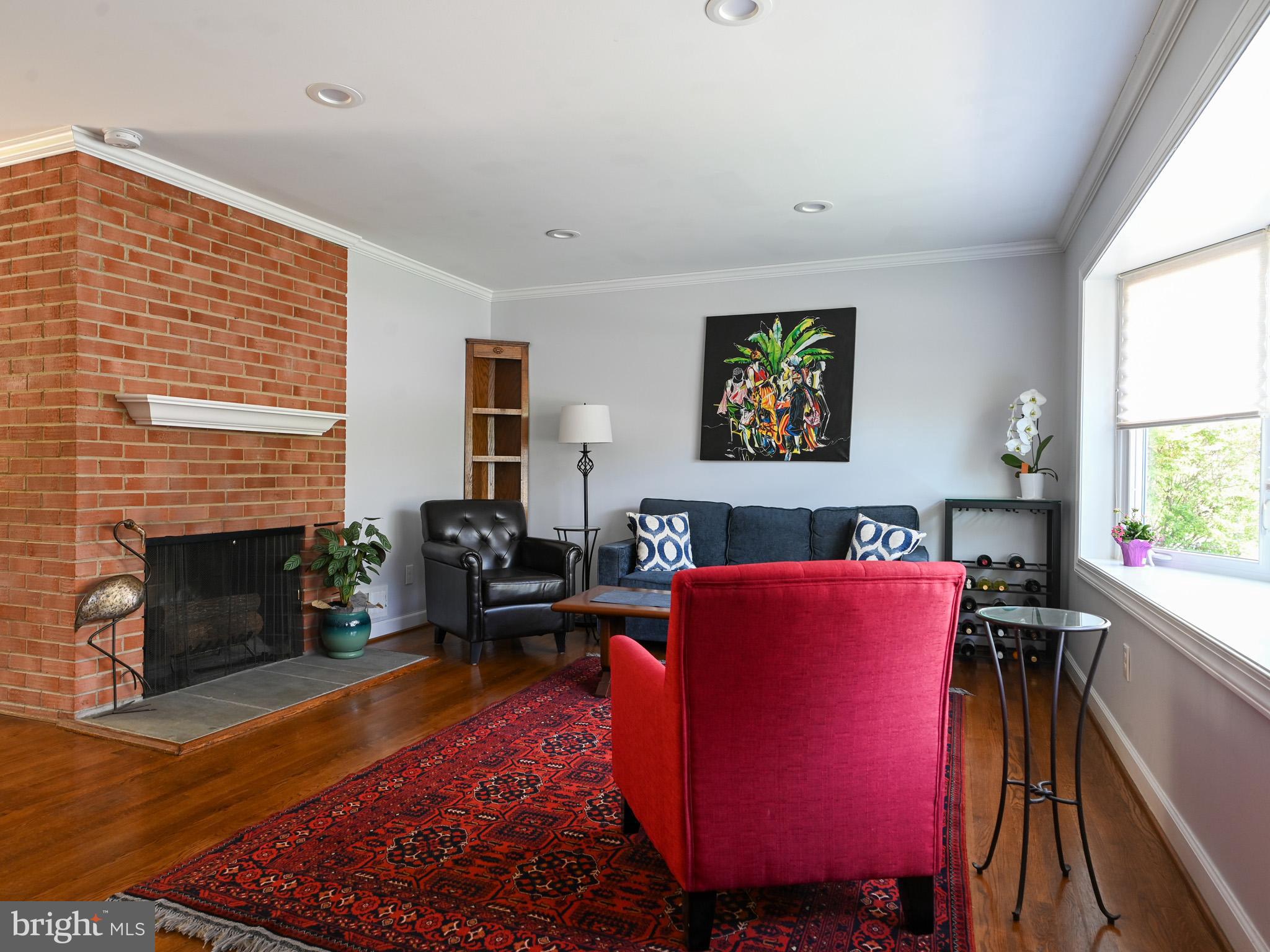 7951 Jansen Drive Springfield, VA 22152 - Photo 4 of 36 a living room with furniture a fireplace and a large window