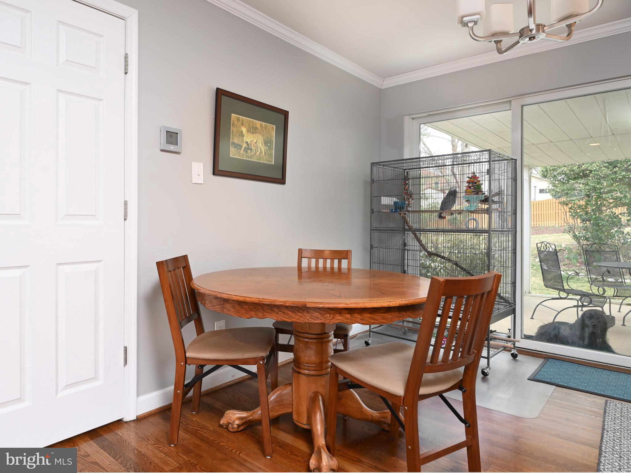 7951 Jansen Drive Springfield, VA 22152 - Photo 7 of 36 a dining room with furniture a large window and wooden floor