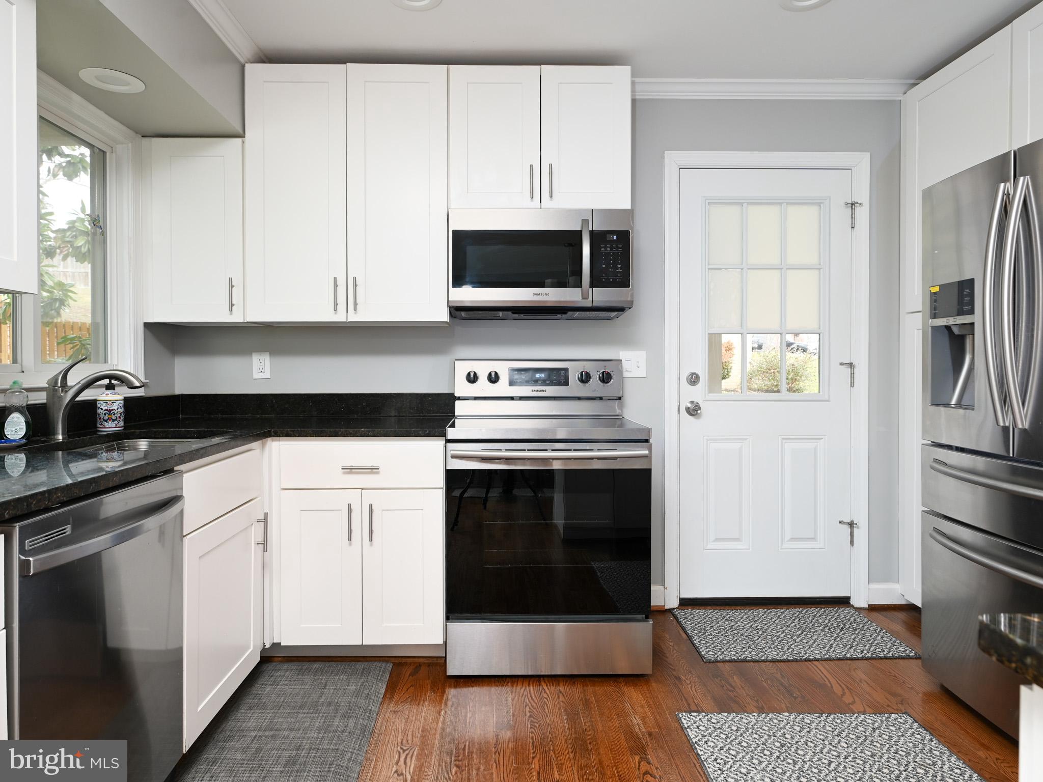 7951 Jansen Drive Springfield, VA 22152 - Photo 10 of 36 a kitchen with stainless steel appliances a stove a microwave and cabinets