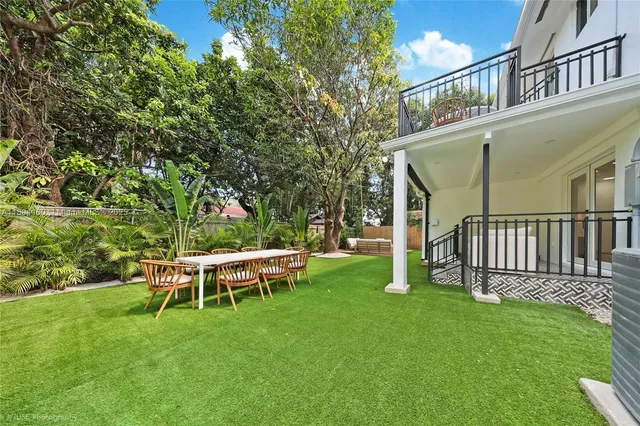a view of a house with backyard porch and sitting area