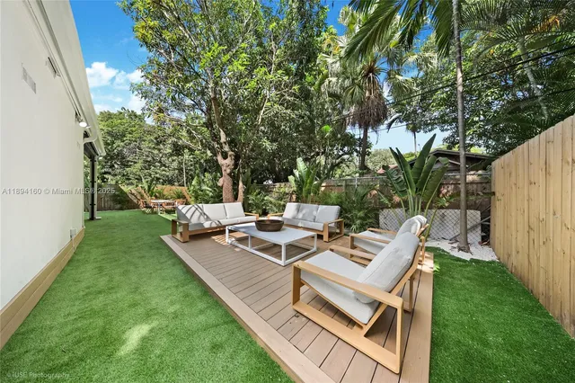 a view of a backyard with sitting area