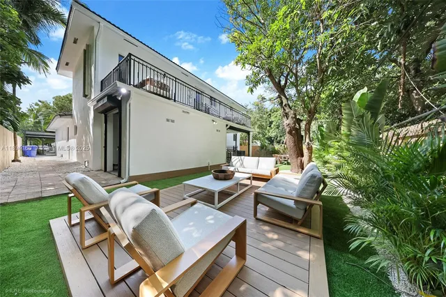 a view of backyard of house with seating space