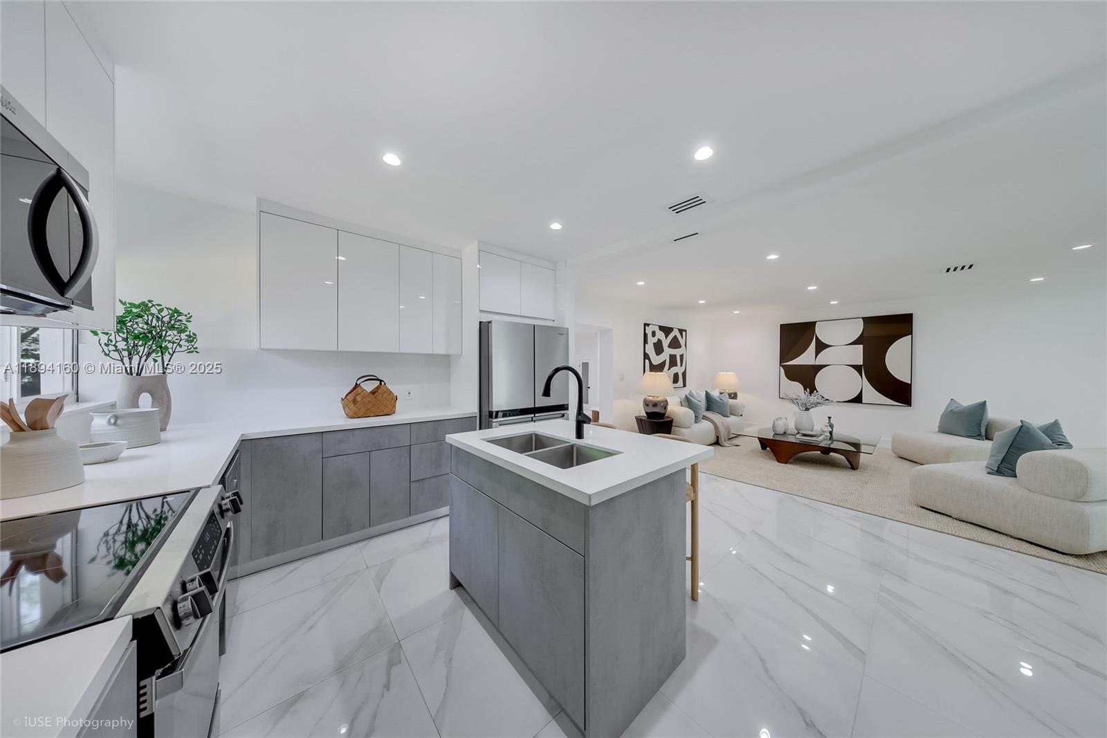 871 Northeast 81st Street Miami, FL 33138 - Photo 10 of 42 a kitchen with white cabinets and sink