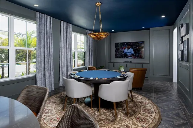 a living room with furniture a fireplace and paintings on the wall