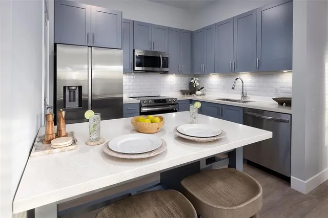 a kitchen with a table chairs stove and microwave