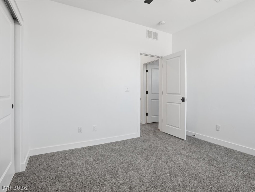 9725 Starlight Ridge Avenue Las Vegas, NV 89148 - Photo 32 of 47 This spacious room offers comfort and versatility, perfect for rest or recreation.