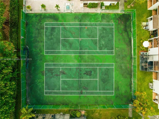 a bed sitting in a bedroom next to a large window