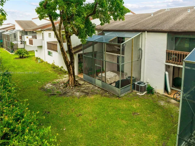 a large white bed in a bedroom next to a window
