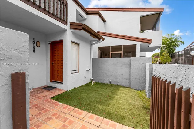 a white toilet sitting next to a shower