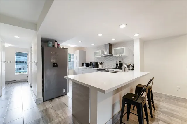 a living room with furniture large window and a flat screen tv