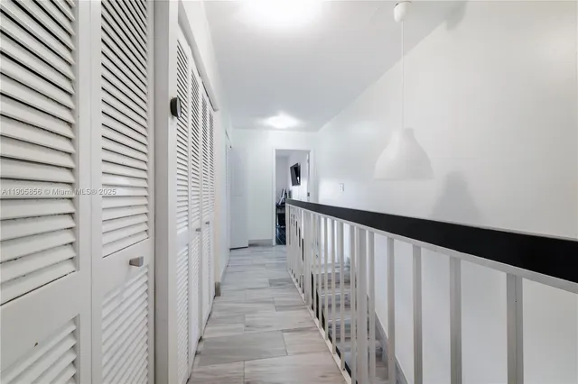 a room with pool table and windows