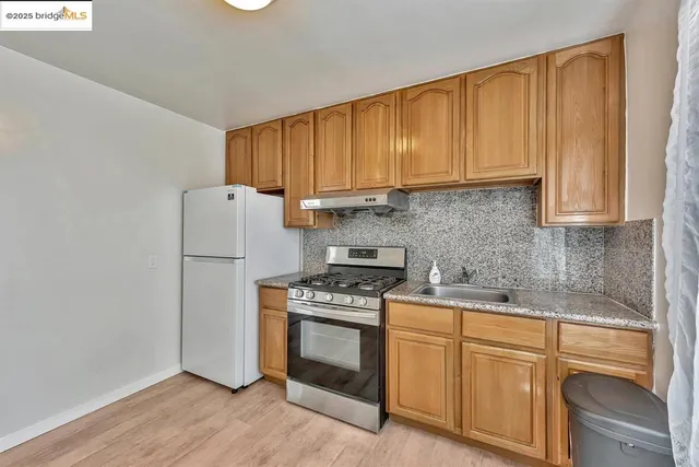 a kitchen with a sink stove and cabinets