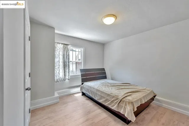 a bedroom with a bed and window