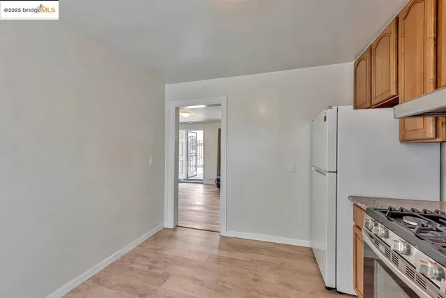 a view of a kitchen with an empty space and a stove top oven