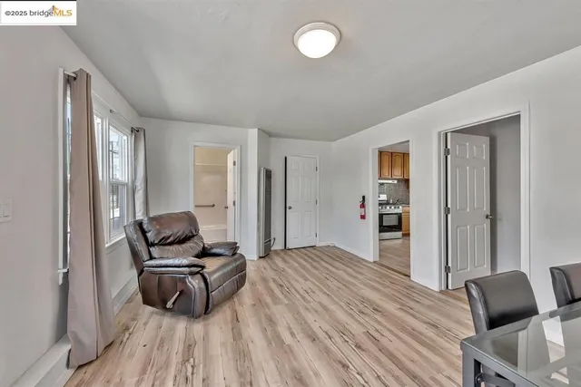 a bedroom with furniture and a wooden floor