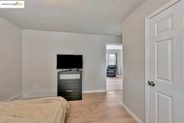 a bedroom with a bed and a television