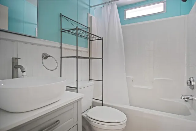 a bathroom with a toilet a sink and bathtub