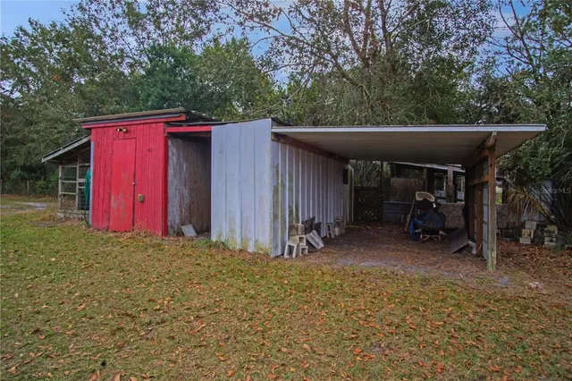 a view of a house with backyard and patio