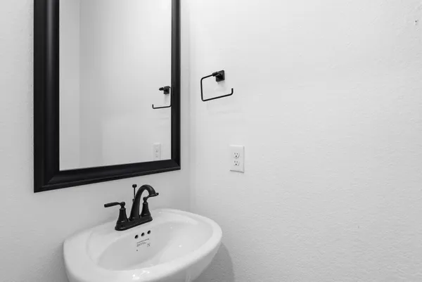 a bathroom with a sink and mirror