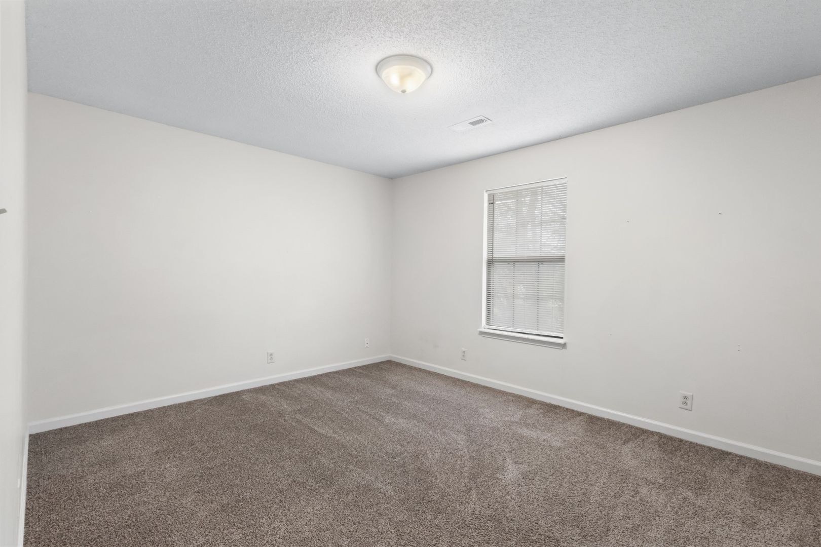 725 Peachers Mill Road Clarksville, TN 37042 - Photo 12 of 15 an empty room with a window