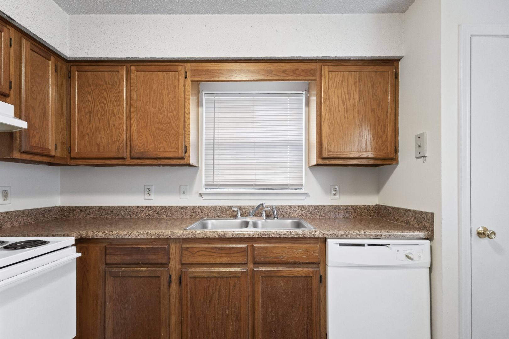 725 Peachers Mill Road Clarksville, TN 37042 - Photo 7 of 15 a kitchen with granite countertop stainless steel appliances white cabinets sink and a granite counter top