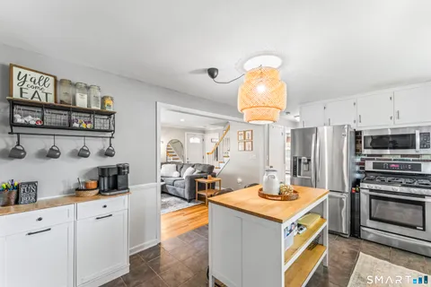 a kitchen with stainless steel appliances a stove a sink and a refrigerator