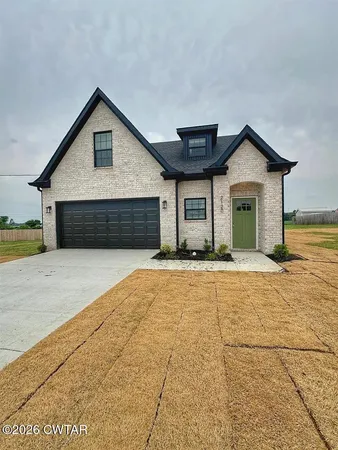 a view of a house with a yard and garage