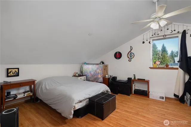 a bedroom with a bed and a large mirror on the dresser