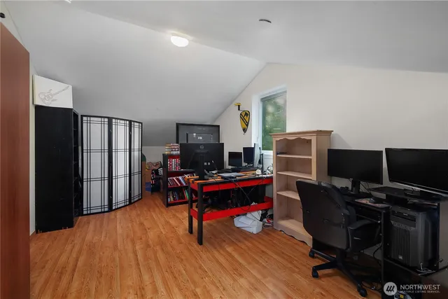 a view of a workspace with furniture and a window