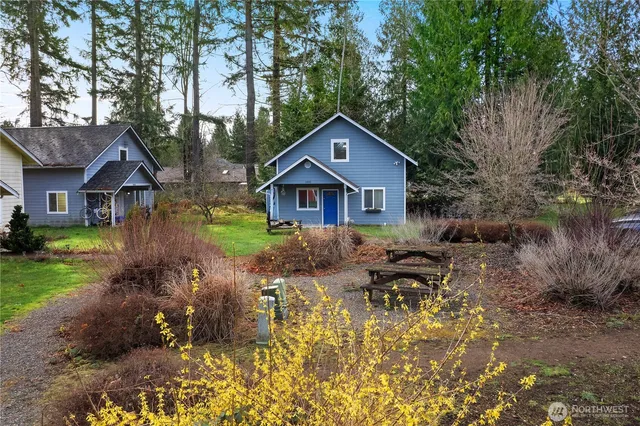a backyard of a house with yard and outdoor seating