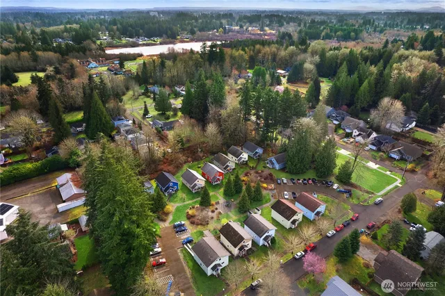 an aerial view of lake and residential houses with outdoor space