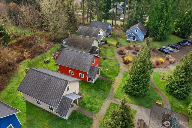 an aerial view of a house with garden space and street view