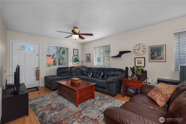 a living room with furniture ceiling fan and a rug