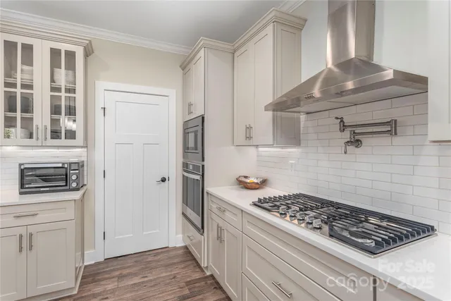 a kitchen with stainless steel appliances a stove and a refrigerator