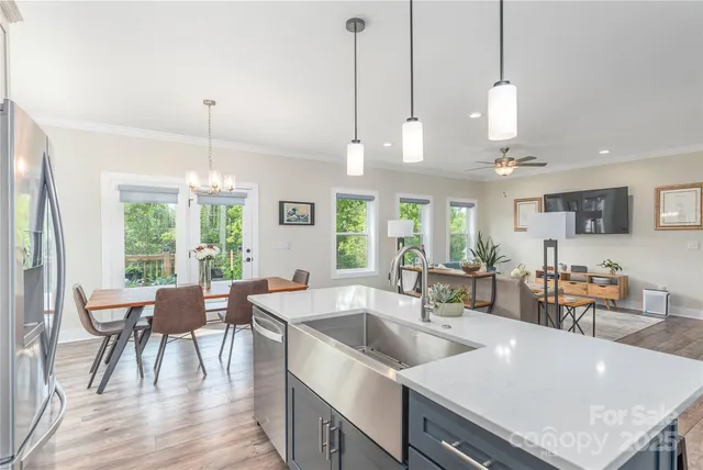 a view of a kitchen and dining room with wooden floor