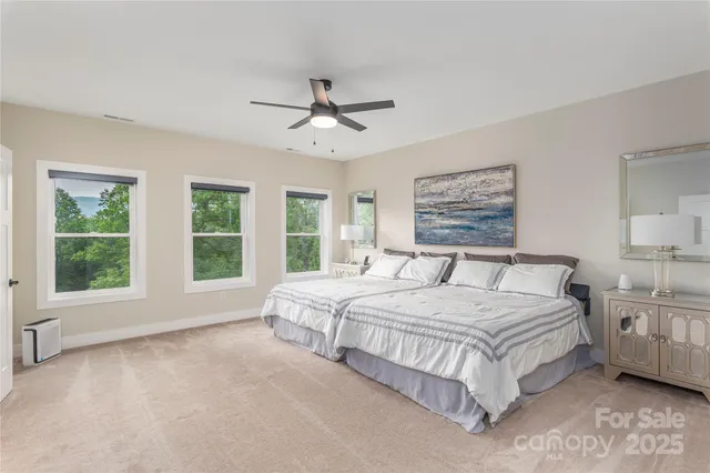 a spacious bedroom with a large bed and a large window