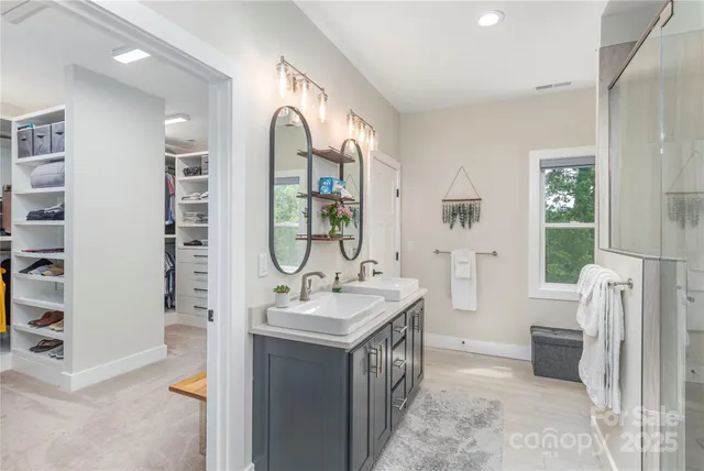 a bathroom with a tub sink and mirror