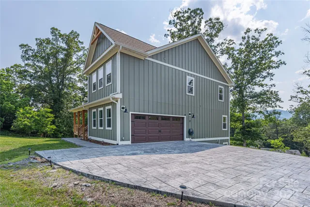 a view of a house with a yard and garage