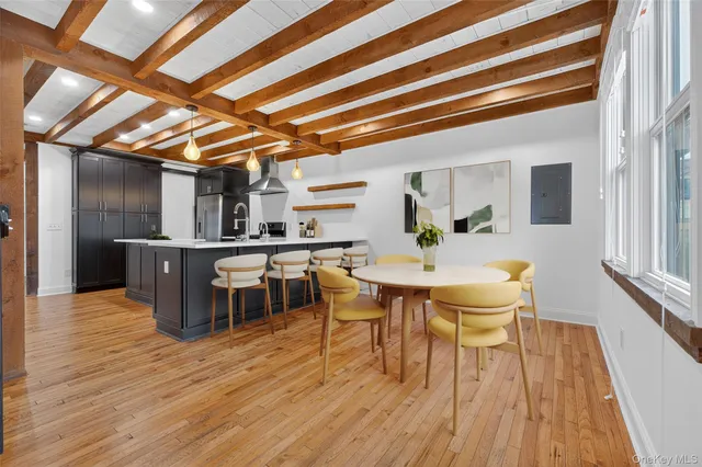 a view of a dining room with furniture and wooden floor