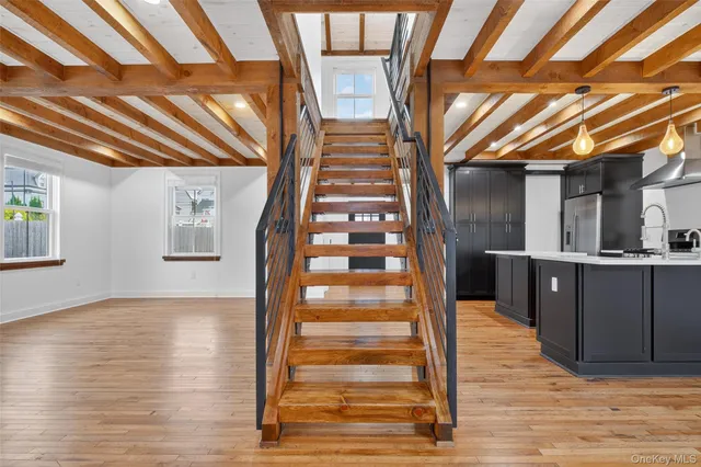 a view of entryway with wooden floor and windows
