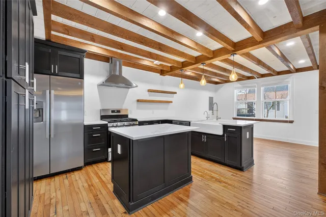 a kitchen with wooden cabinets and stainless steel appliances