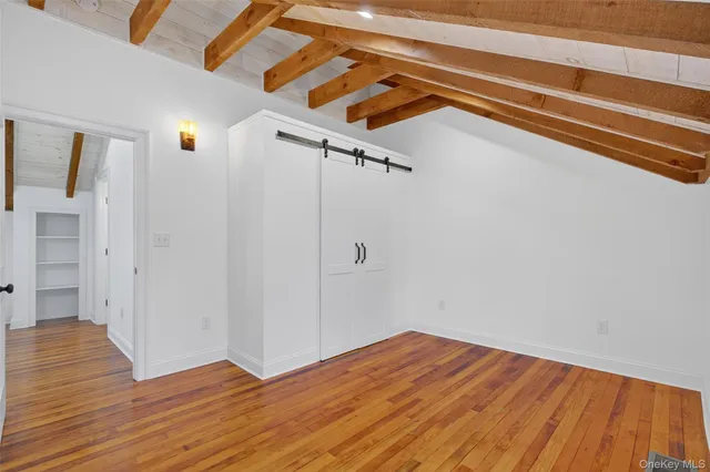 a view of a room with wooden floor