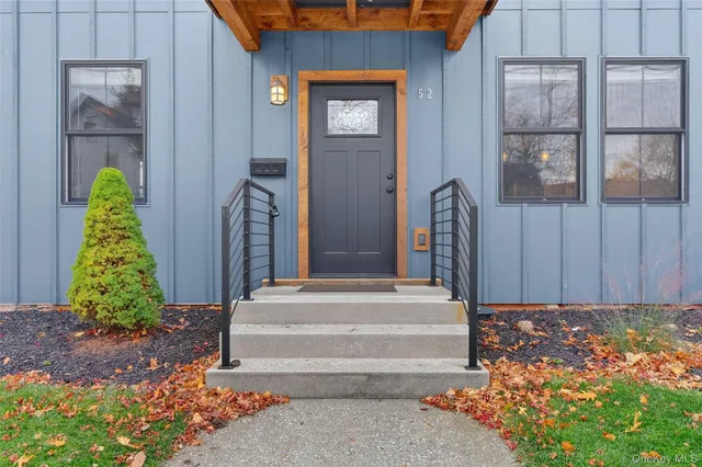 a front view of a house with a garden