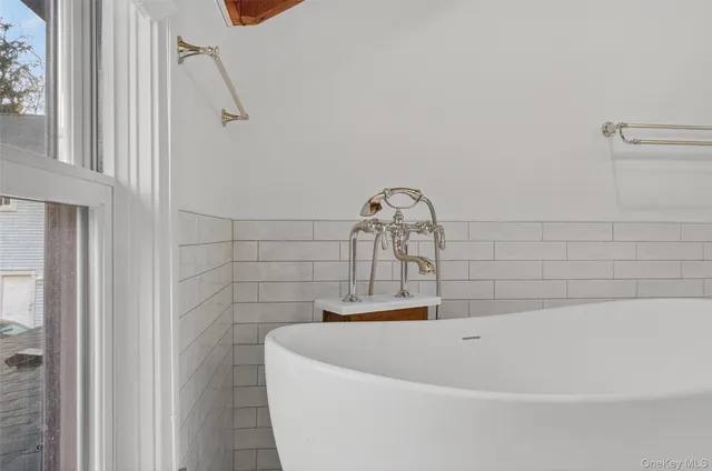 a bath tub sitting next to a shower