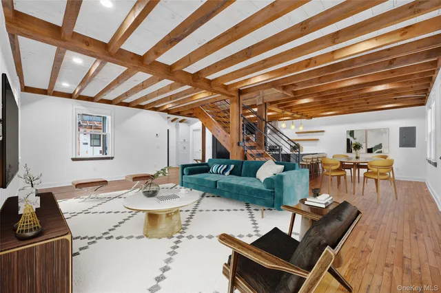 a dining room with furniture and wooden floor