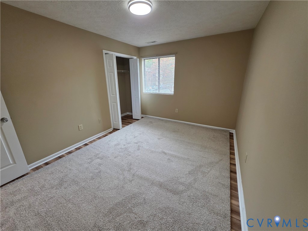 4003 Governors Square, Unit 8 Williamsburg, VA 23188 - Photo 15 of 27 an empty room with windows