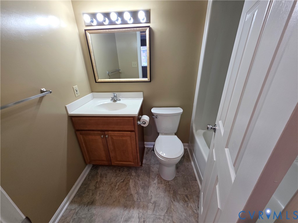 4003 Governors Square, Unit 8 Williamsburg, VA 23188 - Photo 16 of 27 a bathroom with a toilet a sink and mirror