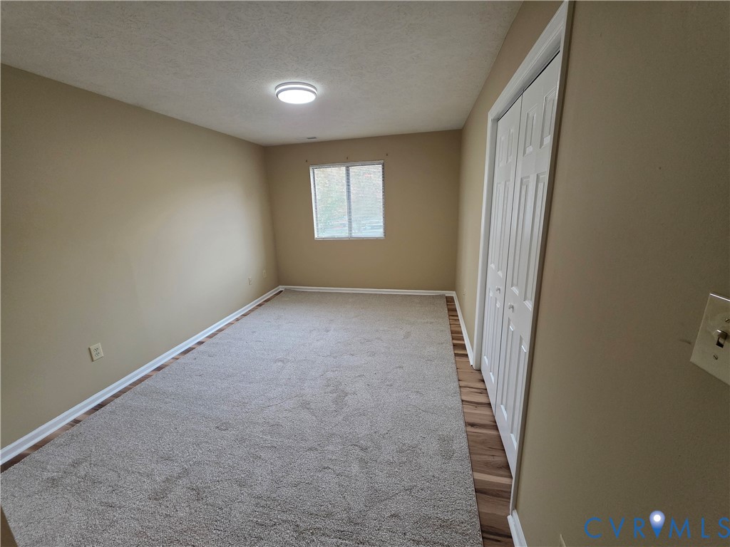 4003 Governors Square, Unit 8 Williamsburg, VA 23188 - Photo 18 of 27 an empty room with windows