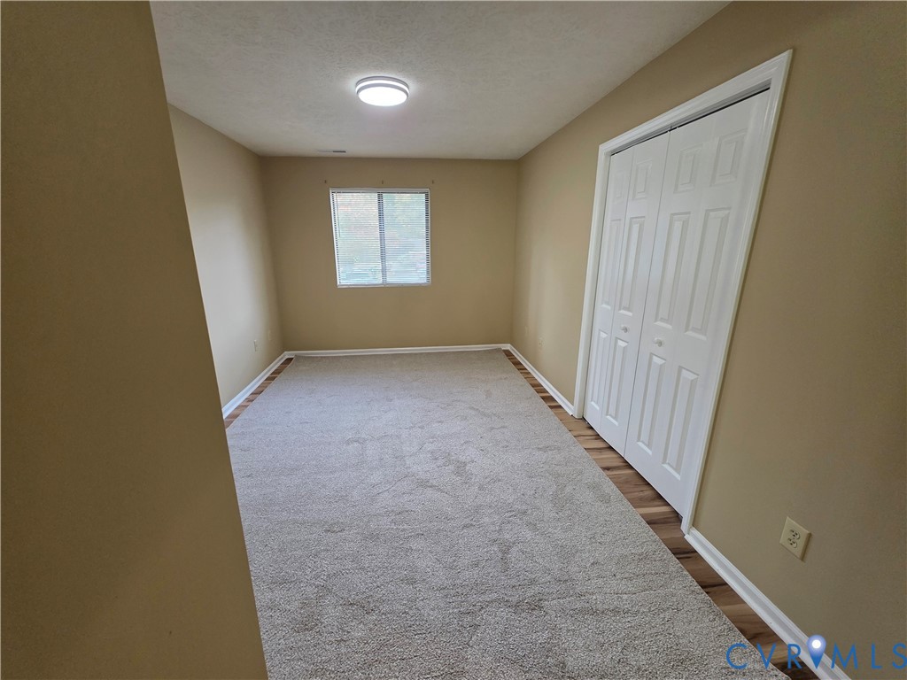 4003 Governors Square, Unit 8 Williamsburg, VA 23188 - Photo 22 of 27 an empty room with windows